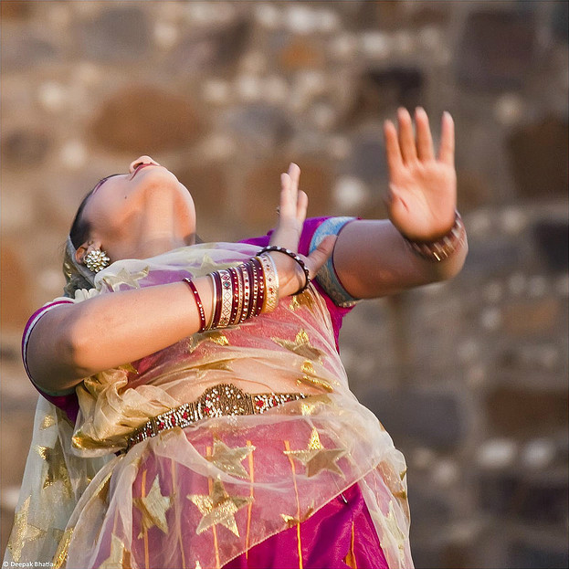 Woman looking backward as she dances